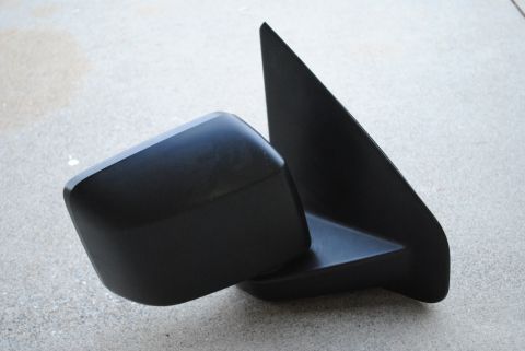 1986 Ford Bronco - Side mirror assembly shown detached from a vehicle.