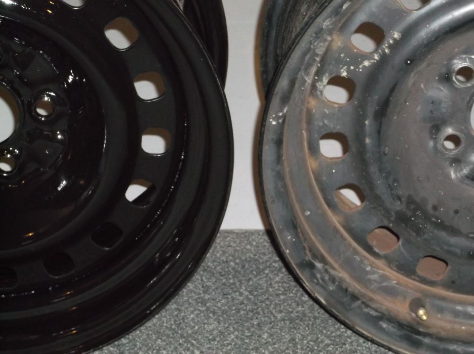 Two black steel wheels, one shiny and new, the other rusted and worn.