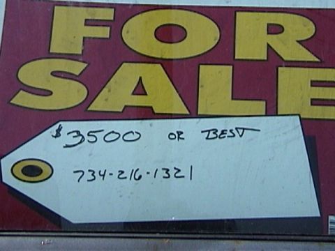 1995 Ford Bronco - A 'FOR SALE' sign with pricing and contact information is displayed.