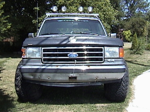 Front view of a 1995 Ford Bronco with a roof rack and off-road lights
