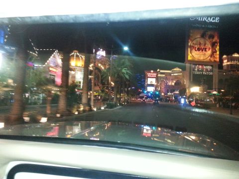 1979 Ford Bronco - Nighttime view of the Las Vegas Strip, including the Mirage and Caesars Palace, seen from the interior of a vehicle.