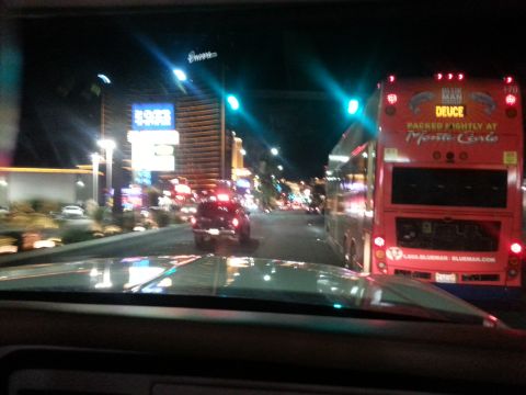 1979 Ford Bronco - Nighttime view of a city street with a tour bus and other vehicles.
