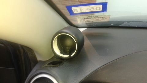 2008 Mazda 3 - Interior shot of a car's dashboard, an aftermarket gauge pod and a Texas inspection sticker.