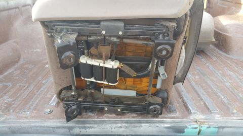 1995 Ford F-150 - The internal workings of a vehicle seat, including its power adjustment components, are visible.