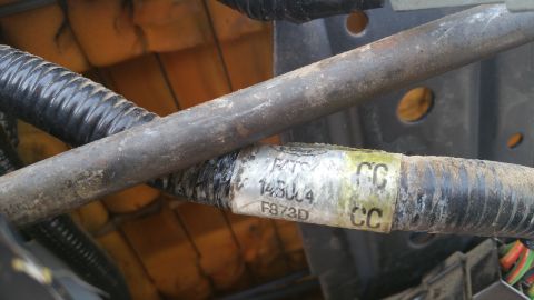 1995 Ford F-150 - A label on a vehicle's wiring harness shows part numbers and identifiers.