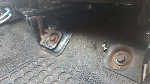 1995 Ford F-150 - Close-up view of the interior floor mounts and pedals in a 1995 Ford F-150 truck.