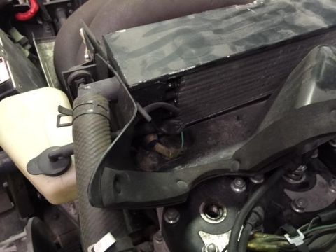 2000 Ford E350 - Close-up view of engine components including a coolant reservoir and radiator.