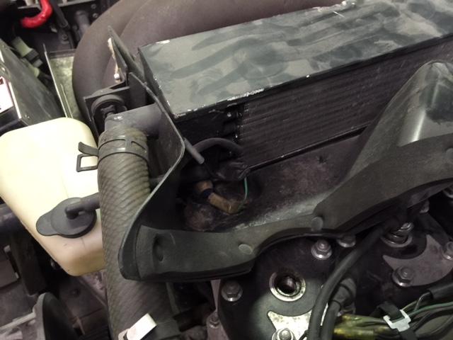 Engine bay with coolant reservoir, radiator, and hoses visible