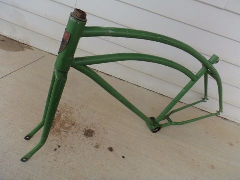 Green bicycle frame with a badge on the head tube