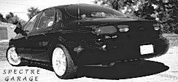1999 Ford Taurus - Rear view of a black 1999 Ford Taurus sedan with custom wheels.
