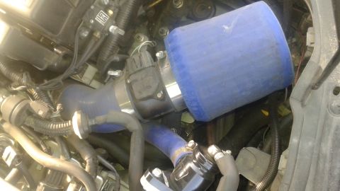 2008 Mazda 3 - Aftermarket air intake system installed in an engine bay.