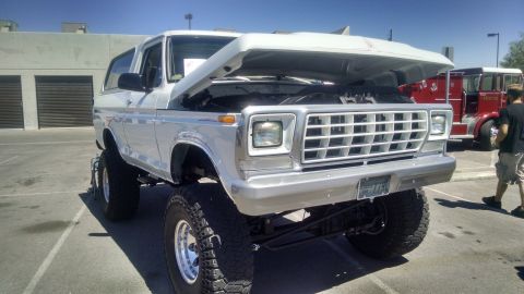 1979 Ford Bronco - This lifted 1979 Ford Bronco is displayed with its hood open, revealing the engine bay.