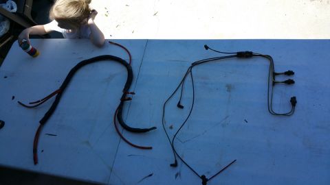 1990 Ford Bronco - Vacuum lines are laid out on a table, with a child in the background.