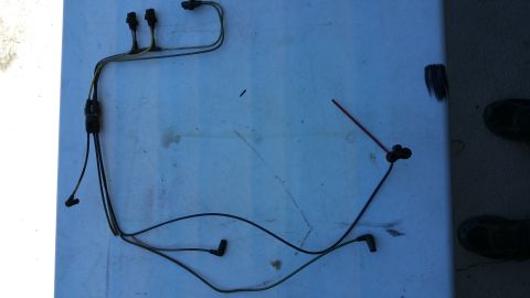 1990 Ford Bronco - Wiring harness laid out on a blue surface, showing connectors and black boots.