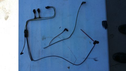 1990 Ford Bronco - A collection of automotive wiring and spark plug wires are displayed on a flat surface.