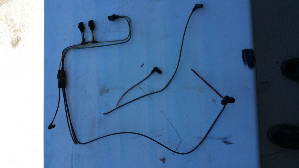 Wiring harness and spark plug wires laid out on a surface