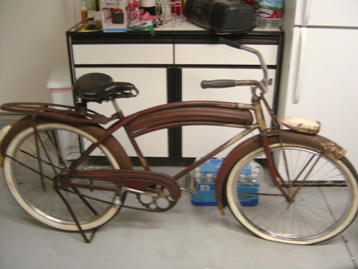 old brown bicycle with white-wall tires, black seat, and a headlight