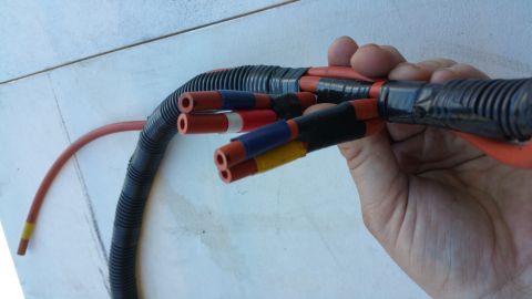 1990 Ford Bronco - A close-up view of a wiring harness with multiple colored connectors.