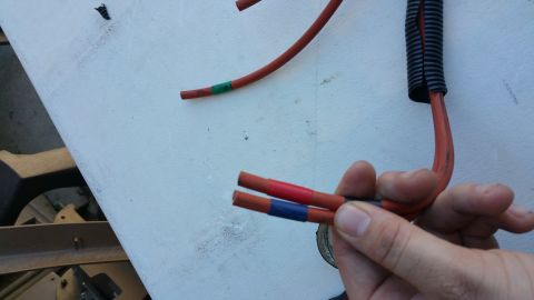 1990 Ford Bronco - Close-up of electrical wires being worked on, with different colored tape indicating connections.