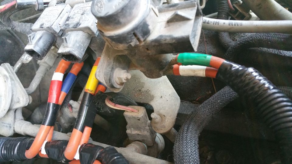 Close-up of engine wiring harness with colored wires and connectors