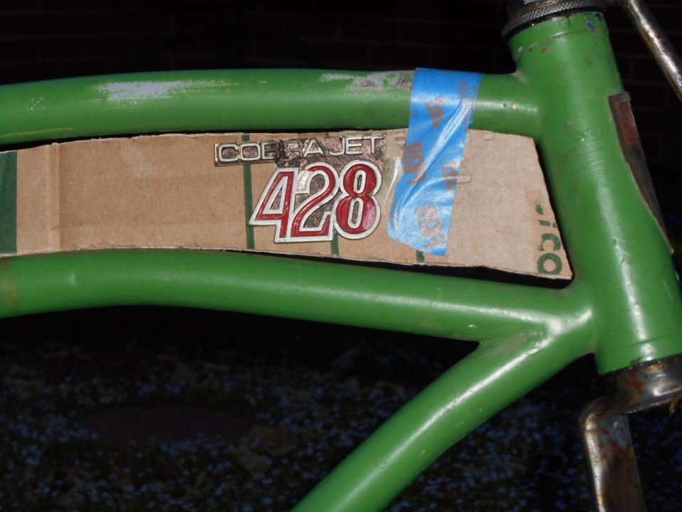 Green bicycle frame with Cobra Jet 428 decal and blue tape