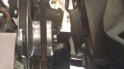 1979 Ford Bronco - A close-up view shows a serpentine belt system with a pulley and a ribbed belt. The belt is tensioned by a shiny metal component, likely pa…