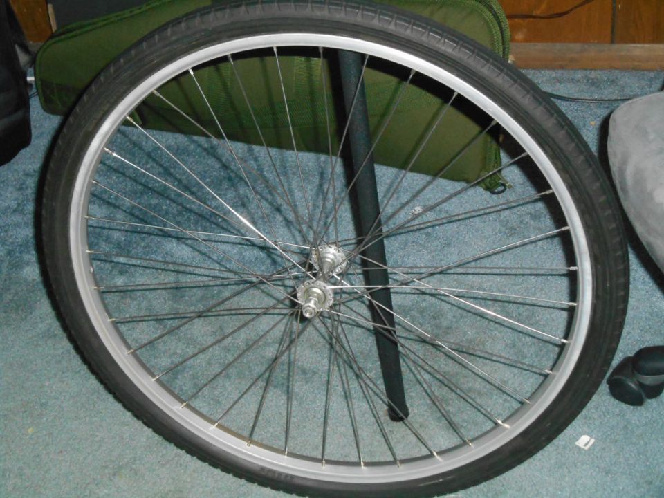 Bicycle wheel with black tire and silver rim