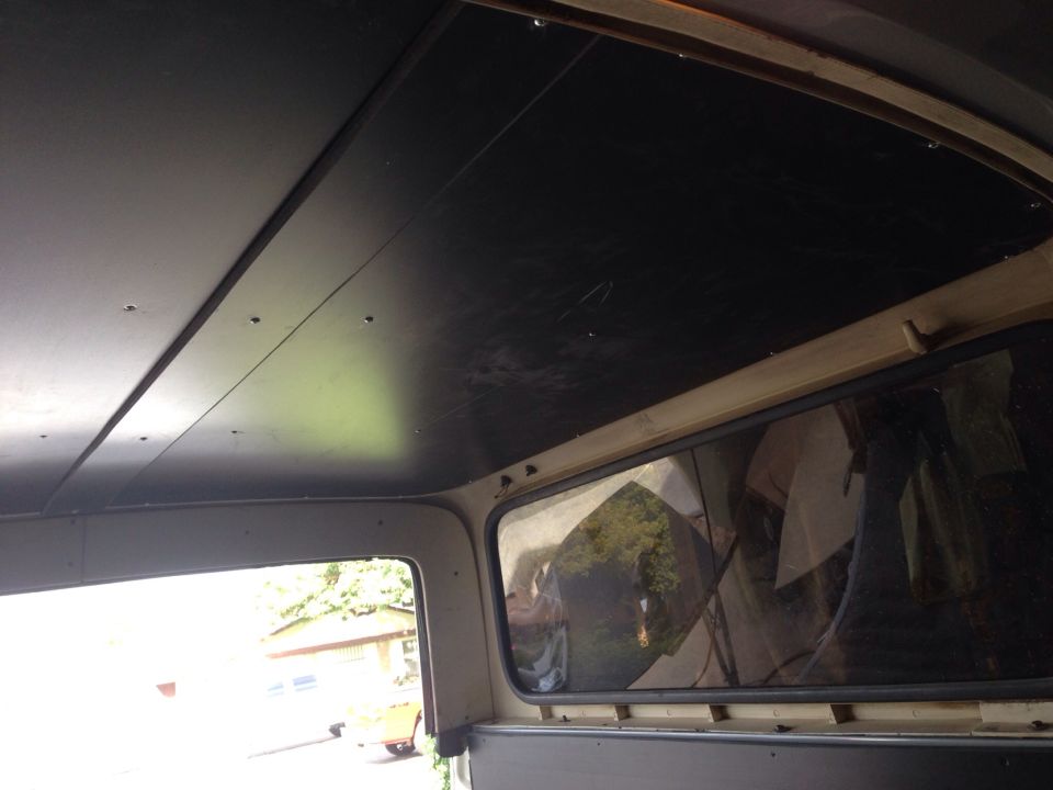 Interior view of a vehicle ceiling and window.