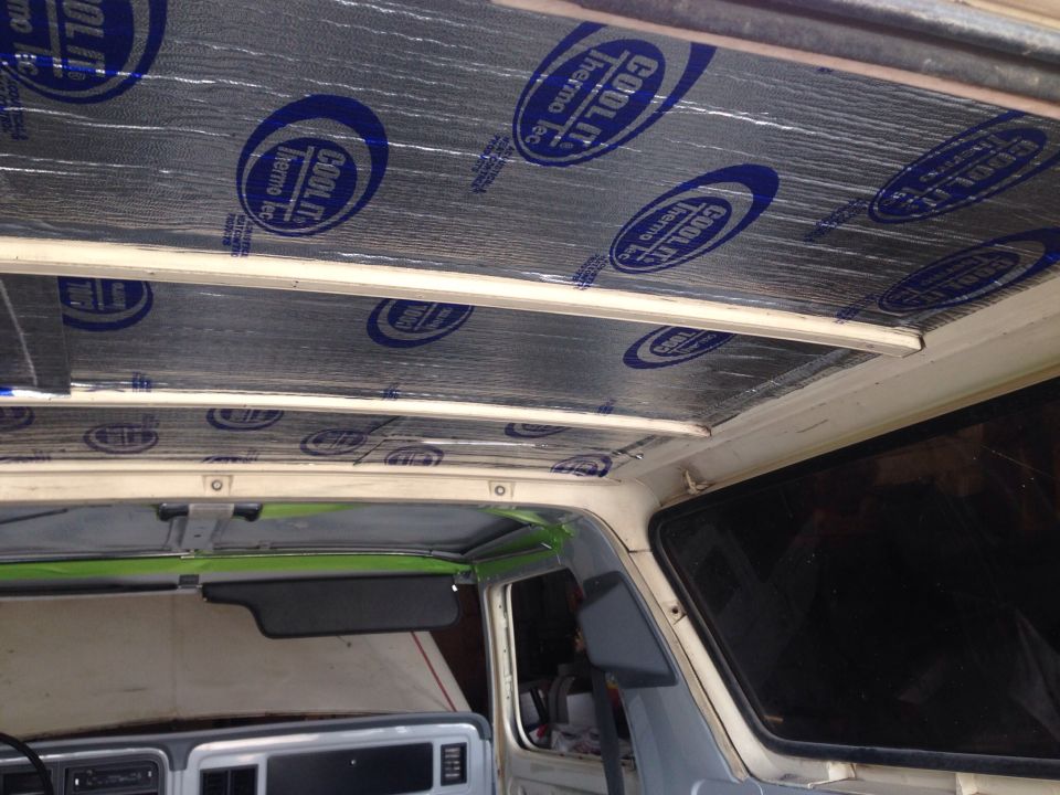 Interior view of a vehicle's ceiling being insulated with Cool It Thermo Tec material.