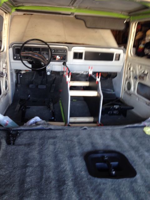 1978 Ford Bronco - The interior of a classic Ford truck or SUV is shown during a restoration. The dashboard, steering wheel, and floor are visible, along with…
