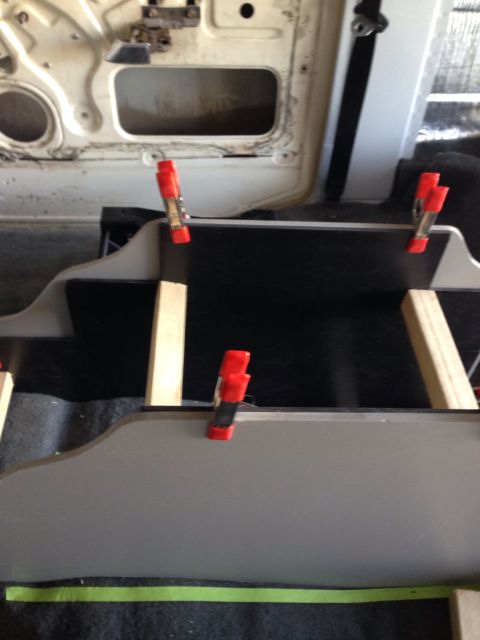 1978 Ford Bronco - A close-up view shows red spring clamps holding together parts of a vehicle's interior. The background reveals a portion of a vehicle door…