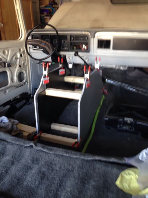 1978 Ford Bronco - The interior of a classic Ford Bronco is shown with the dashboard and steering wheel visible. A custom console or mounting bracket is being…