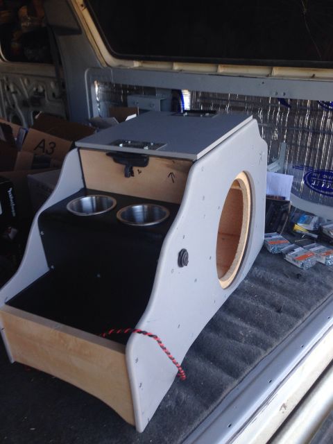 1978 Ford Bronco - A custom-built center console with cup holders and a speaker enclosure is shown in the back of a vehicle. The console is made of wood and g…