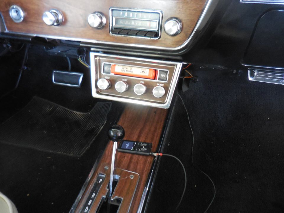 1967 Pontiac GTO interior: woodgrain dash with Pontiac radio, 8-track player with John Mayall tape, console shifter and MP3 player