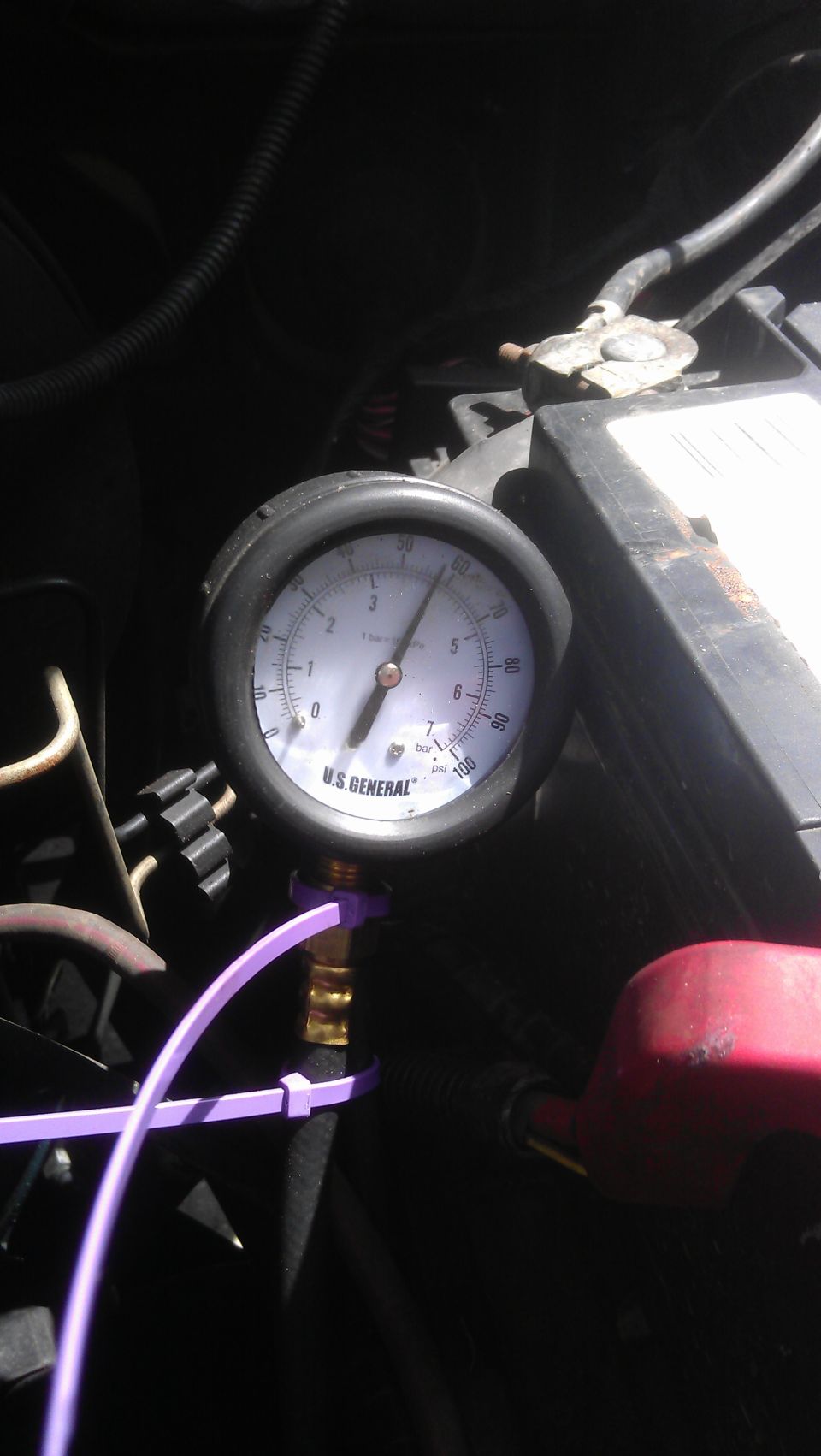 Close-up of a U.S. General pressure gauge showing approximately 1 bar or 15 psi.