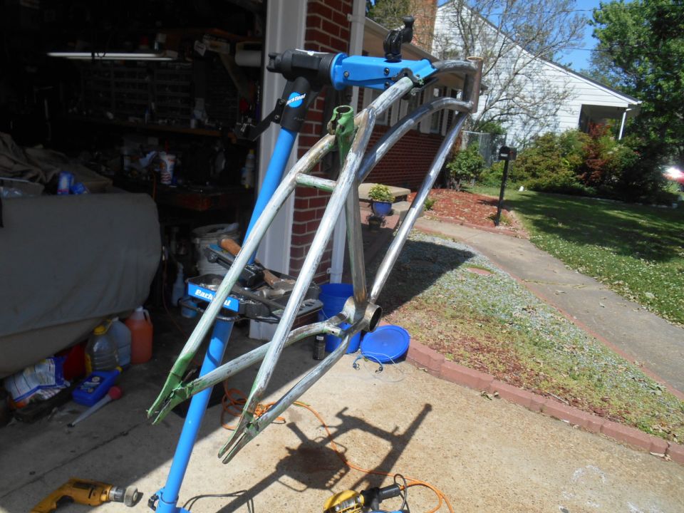 Bicycle frame on a repair stand, possibly being prepped for painting.