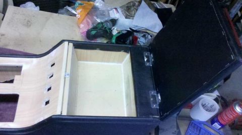1982 Ford Bronco - The image shows an open wooden storage console, possibly for a vehicle's interior. The console is upholstered in black material and feature…