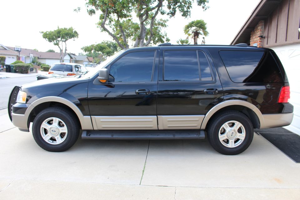 Black 2003 Ford Expedition SUV parked on a driveway.