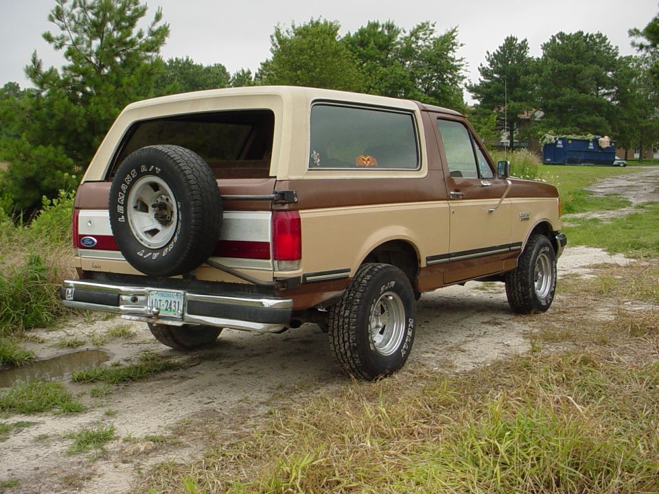 1987 Ford Bronco rear view, two-tone brown and tan, spare tire on door