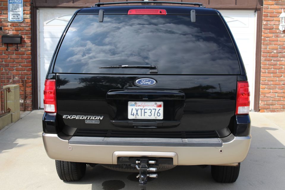 Rear view of a black 2003 Ford Expedition SUV with a trailer hitch