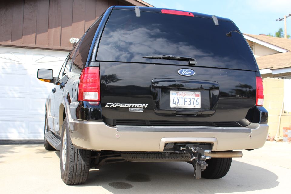 Black Ford Expedition rear view with California license plate 4XTF376 and trailer hitch
