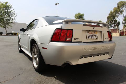 2002 Ford Mustang - Rear view of a silver 2002 Ford Mustang GT with a spoiler and GT badging.