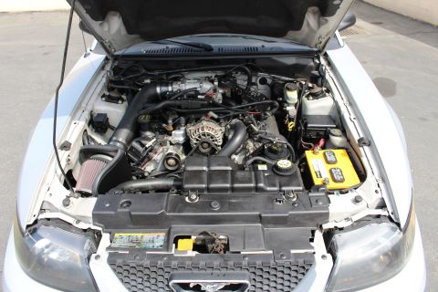 2002 Ford Mustang - Engine bay of a 2002 Ford Mustang, showing the V8 engine and various components.