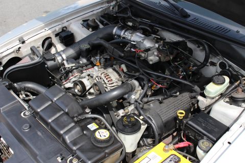 2002 Ford Mustang - Engine bay of a 2002 Ford Mustang, showing the V8 engine and associated components.