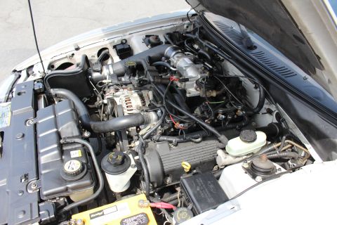 2002 Ford Mustang - The engine bay of a 2002 Ford Mustang, showing the V8 engine and associated components.