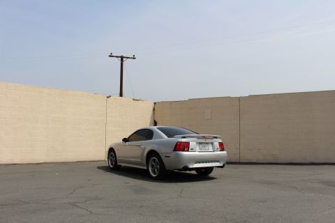 2002 Ford Mustang - Rear view of a silver 2002 Ford Mustang coupe parked in an outdoor lot.