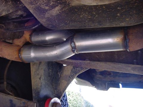 1989 Ford Bronco - Custom exhaust y-pipe installation shown from underneath the vehicle.