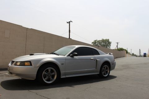 2002 Ford Mustang - A silver 2002 Ford Mustang coupe is seen from a 3q-front angle on a sunny day.