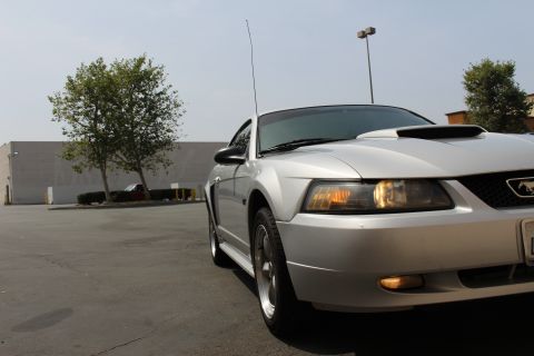 2002 Ford Mustang - Front passenger side view of a silver 2002 Ford Mustang parked in a lot.