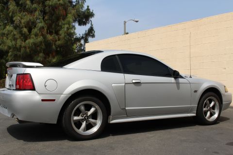 2002 Ford Mustang - This silver 2002 Ford Mustang coupe is shown from the rear quarter angle.